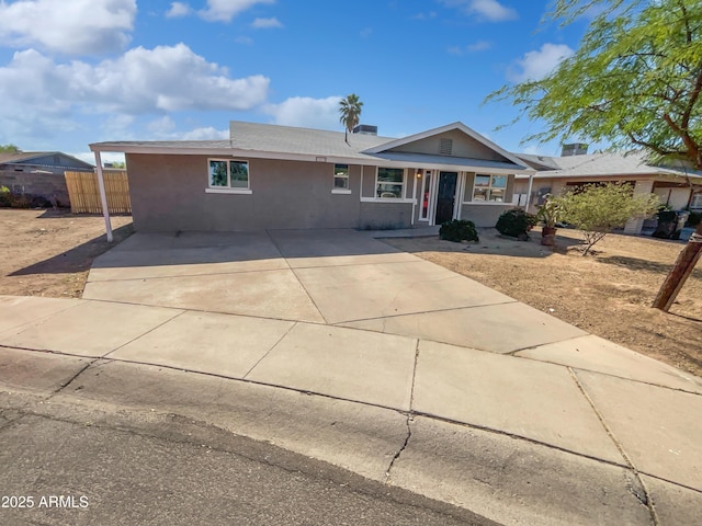 single story home with fence and concrete driveway