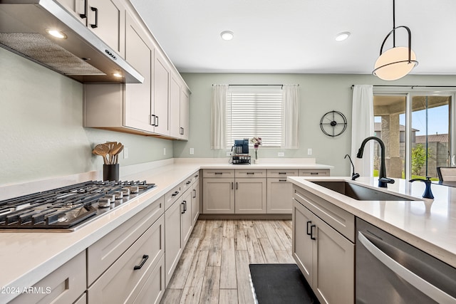 kitchen with plenty of natural light, sink, hanging light fixtures, and appliances with stainless steel finishes