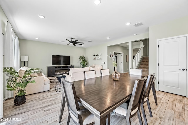 dining area with ceiling fan and light wood-type flooring