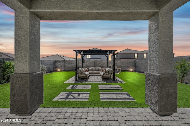 patio terrace at dusk with outdoor lounge area, a yard, and a pergola