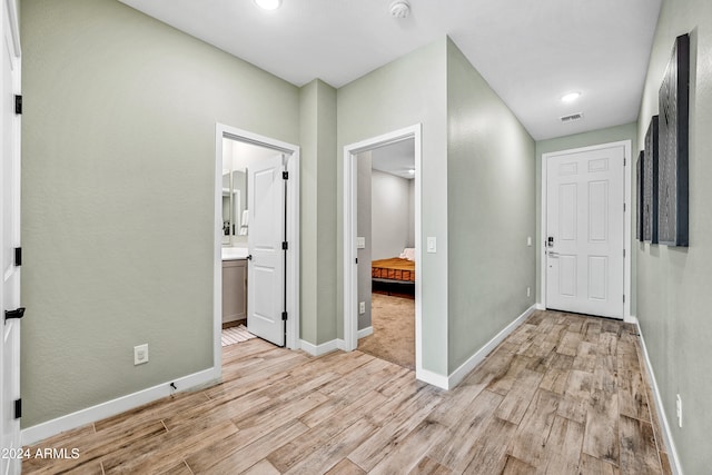 hall with light hardwood / wood-style flooring