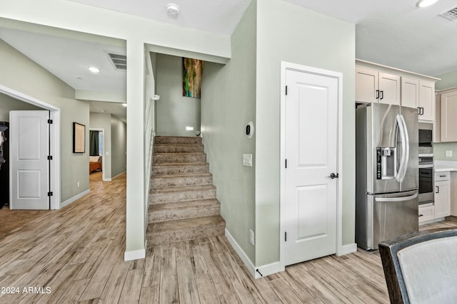 staircase with hardwood / wood-style flooring