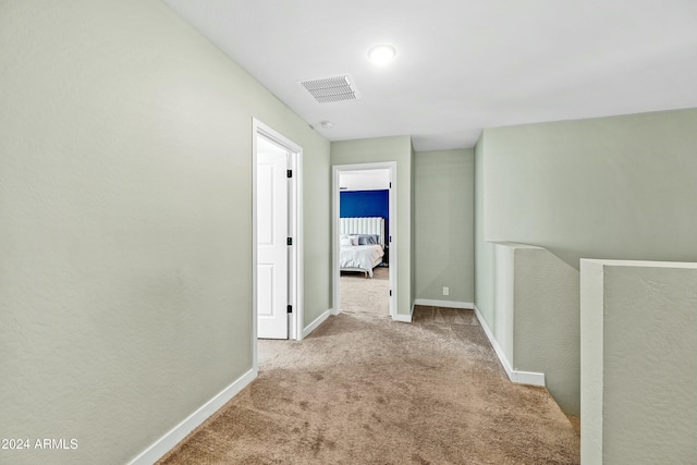 hallway featuring light carpet