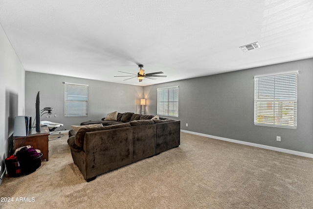 living room with ceiling fan and light carpet