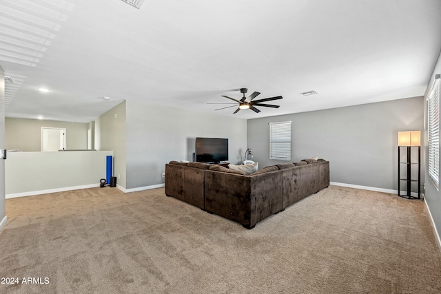 carpeted living room featuring ceiling fan