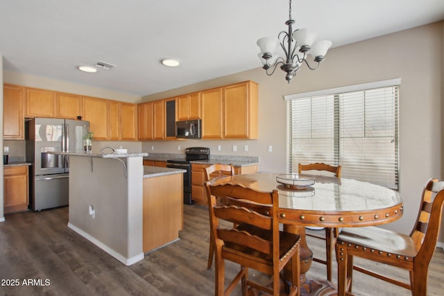 kitchen featuring a center island, pendant lighting, electric range, light stone countertops, and stainless steel fridge with ice dispenser