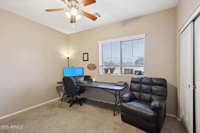 home office with light carpet, baseboards, visible vents, and ceiling fan