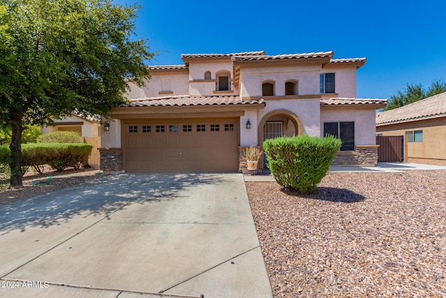 mediterranean / spanish-style house with a garage