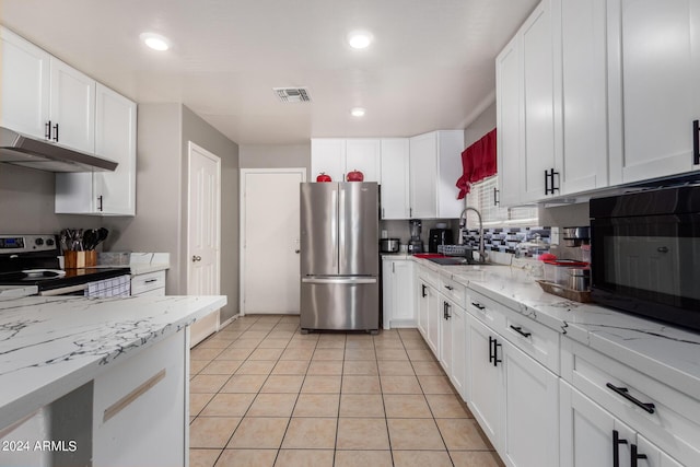 kitchen featuring stainless steel appliances, white cabinetry, sink, and light tile patterned floors