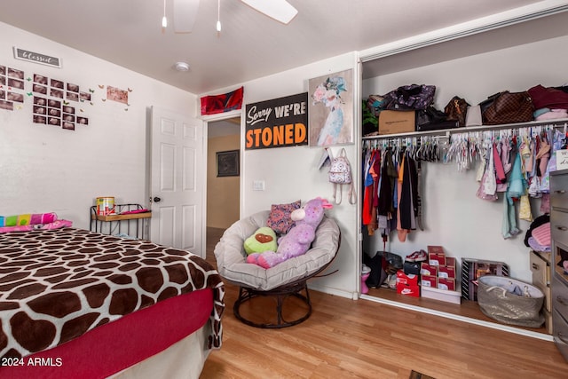 bedroom with ceiling fan, a closet, and wood-type flooring