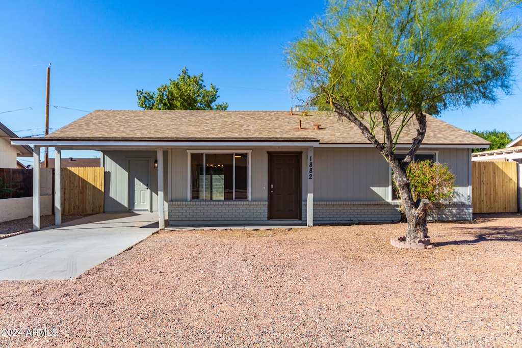 ranch-style house featuring a carport