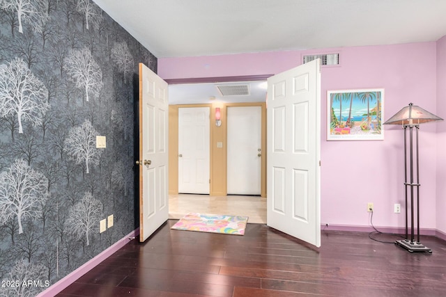 unfurnished bedroom featuring dark hardwood / wood-style floors