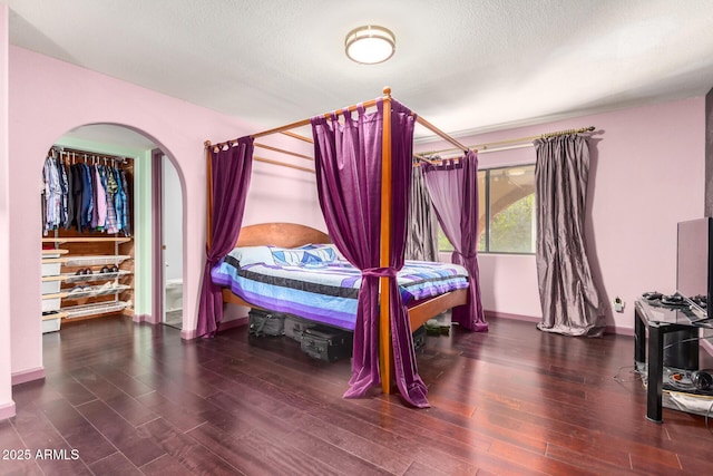 bedroom featuring dark wood-type flooring and a textured ceiling