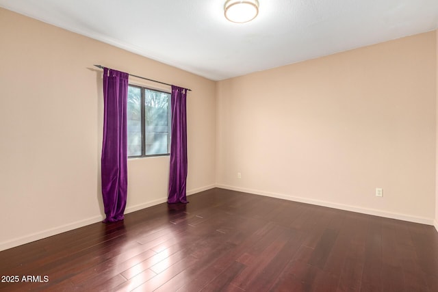 empty room featuring dark wood-type flooring