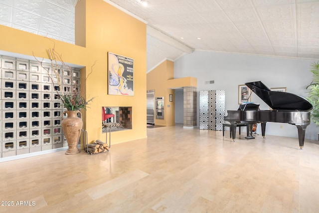 interior space with hardwood / wood-style flooring, high vaulted ceiling, and beamed ceiling