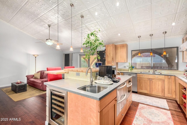 kitchen with hanging light fixtures, sink, beverage cooler, and dark hardwood / wood-style floors