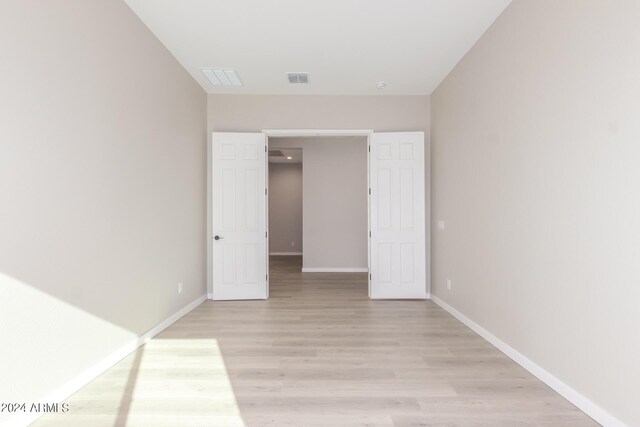 unfurnished bedroom featuring light colored carpet and a closet