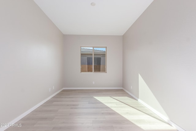 unfurnished room with light wood-type flooring