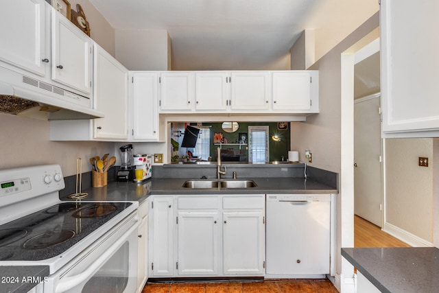 kitchen featuring white appliances, white cabinetry, and sink