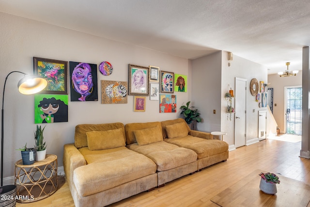 living room featuring hardwood / wood-style floors and an inviting chandelier