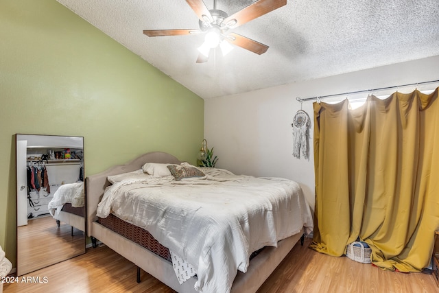 bedroom featuring a textured ceiling, ceiling fan, a closet, and wood-type flooring