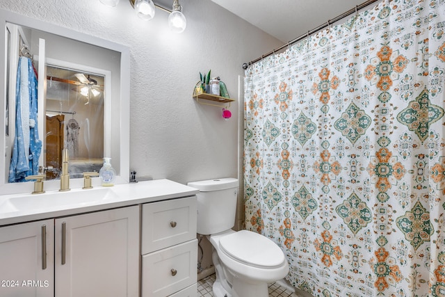 bathroom with ceiling fan, tile patterned floors, vanity, and toilet