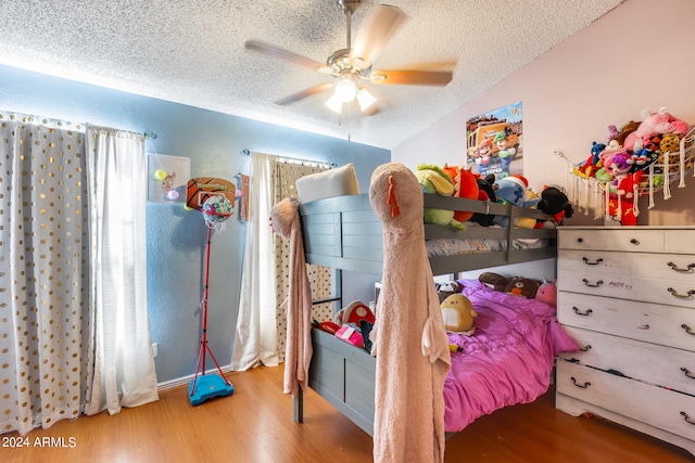 bedroom featuring a textured ceiling, ceiling fan, and hardwood / wood-style floors