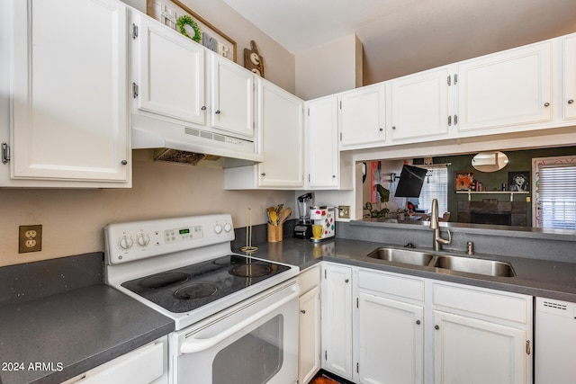 kitchen featuring white appliances, white cabinetry, and sink