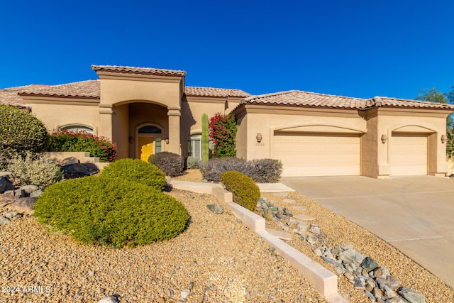 mediterranean / spanish-style house featuring a garage