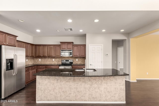 10910 E Sebring Ave, Mesa, AZ 85212 - kitchen with appliances with stainless steel finishes, dark wood-style floors, a center island with sink, backsplash, and recessed lighting