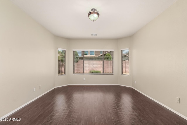 10910 E Sebring Ave, Mesa, AZ 85212 - empty room featuring dark wood-style flooring and baseboards
