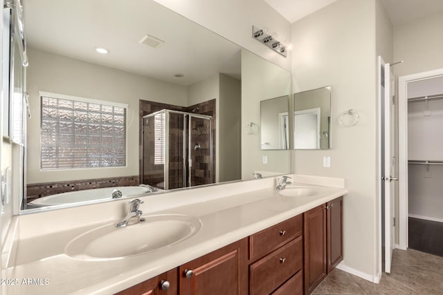 10910 E Sebring Ave, Mesa, AZ 85212 - bathroom with a stall shower, a garden tub, a spacious closet, double vanity, and recessed lighting