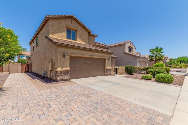 10910 E Sebring Ave, Mesa, AZ 85212 - view of front of house featuring concrete driveway, stucco siding, stone siding, and a garage