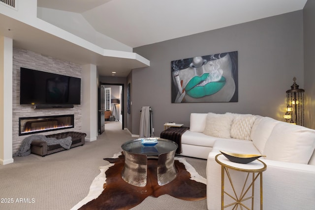 living room featuring vaulted ceiling, carpet, and a fireplace