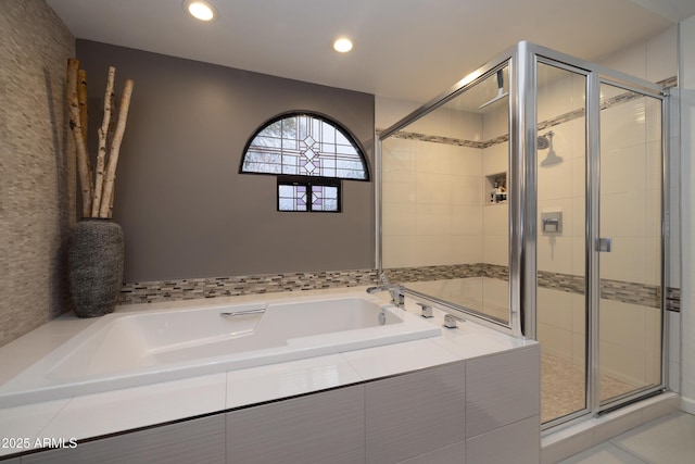 bathroom featuring separate shower and tub