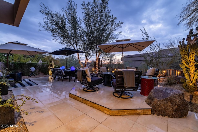 view of patio terrace at dusk