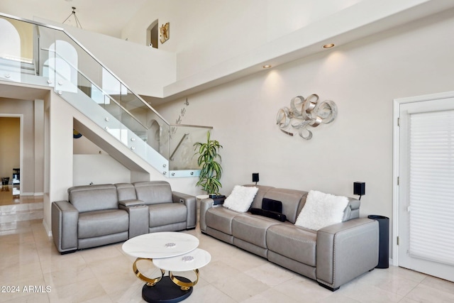 living room featuring a towering ceiling