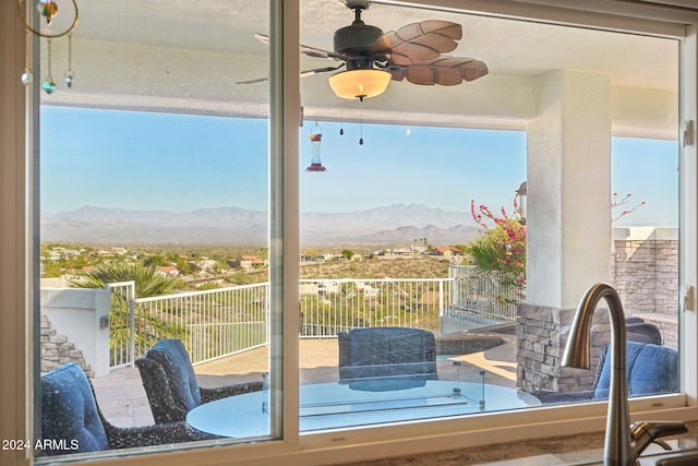 entryway featuring a mountain view and ceiling fan