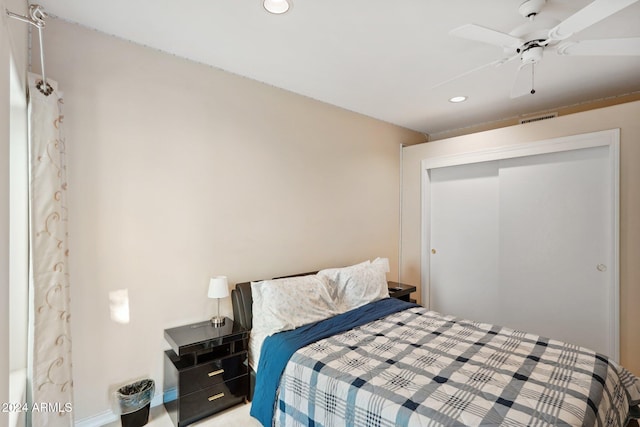 bedroom featuring ceiling fan and a closet