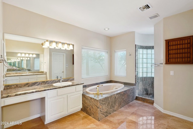 bathroom with vanity and shower with separate bathtub