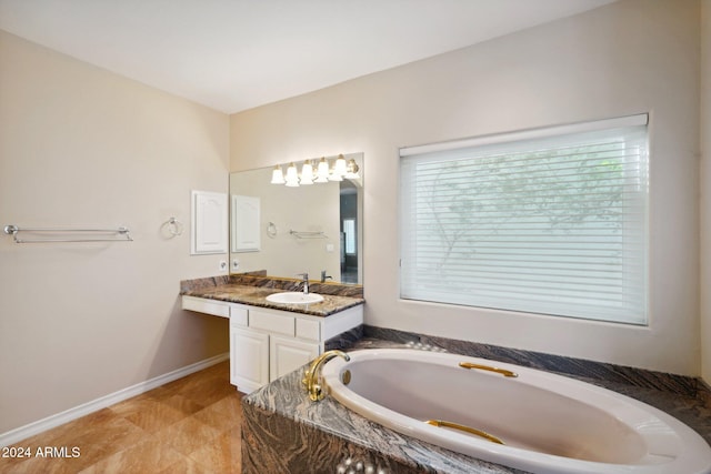 bathroom with vanity and tiled tub