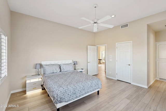 bedroom with light hardwood / wood-style floors and ceiling fan