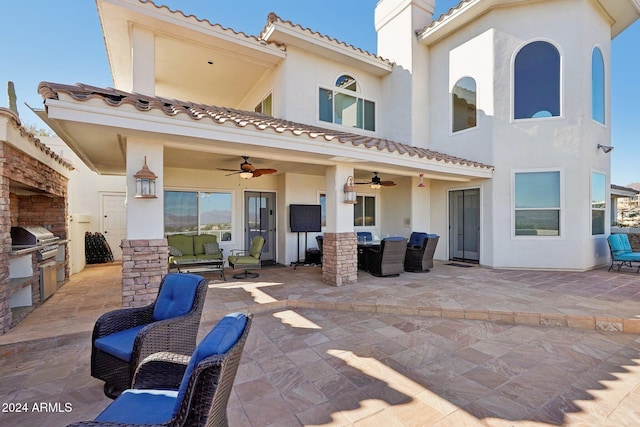 back of property featuring a patio area and exterior kitchen