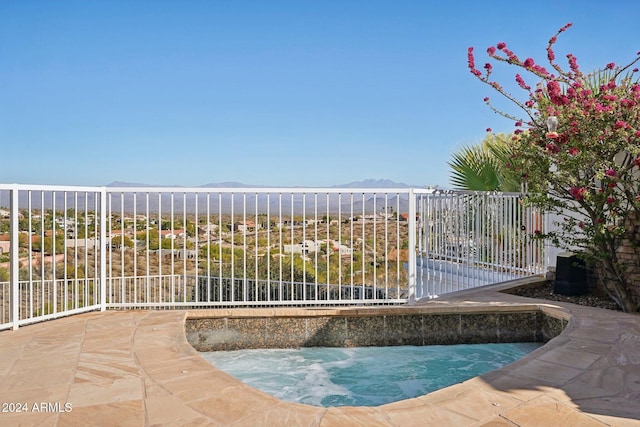 view of pool with a water and mountain view