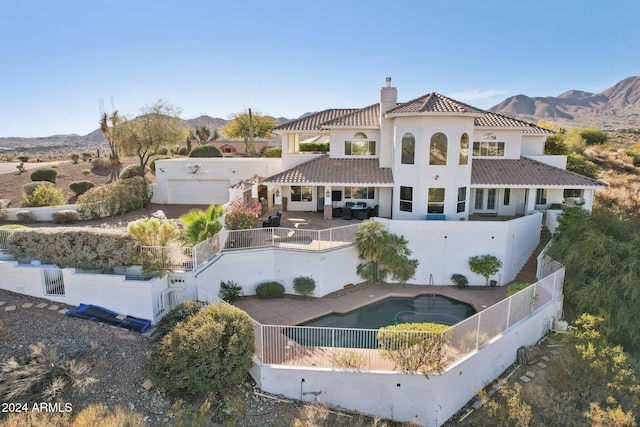 back of house featuring a mountain view and a patio area