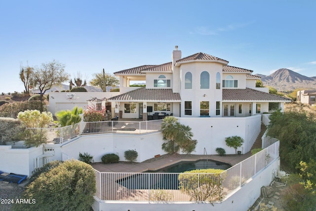 back of property with a mountain view