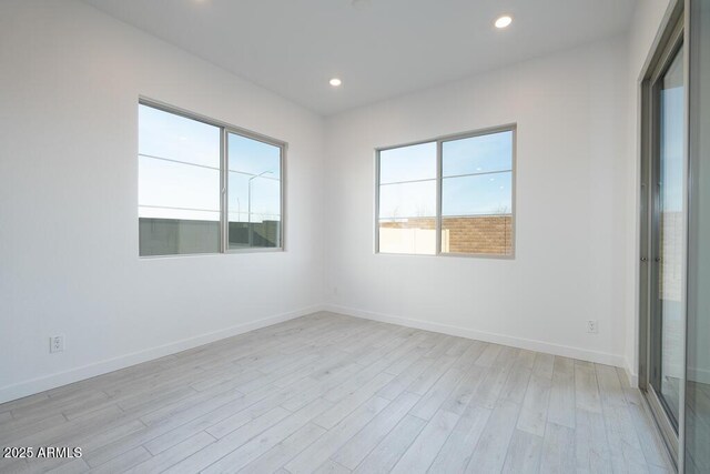 spare room featuring light hardwood / wood-style flooring