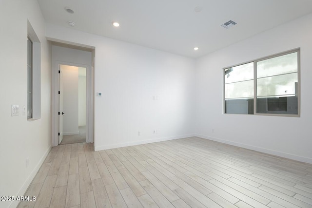 empty room with light hardwood / wood-style flooring