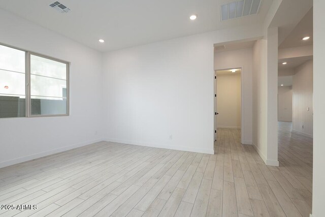 unfurnished room with light wood-type flooring