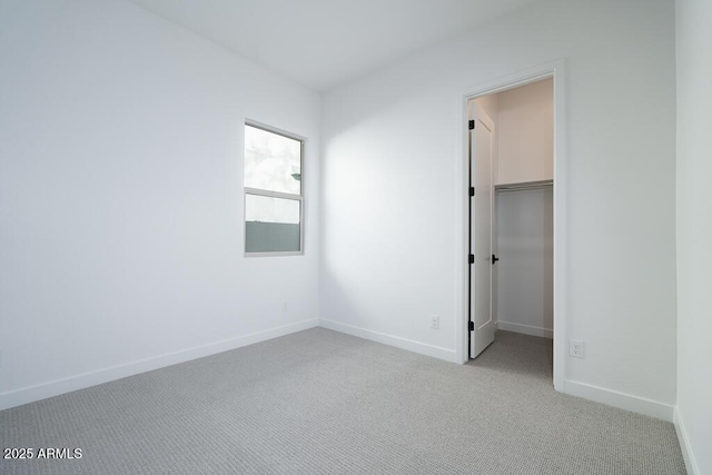 unfurnished room featuring light carpet